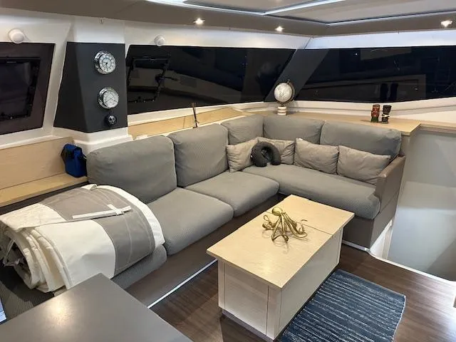 Carpe Aura Yacht Photos Pics Luxurious interior of 2018 Fountaine Pajot Helia 44 catamaran with cozy seating area.