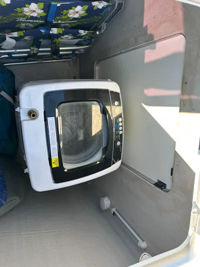 Carpe Aura Yacht Photos Pics Washing machine inside 2018 Fountaine Pajot Helia 44 catamaran storage compartment.