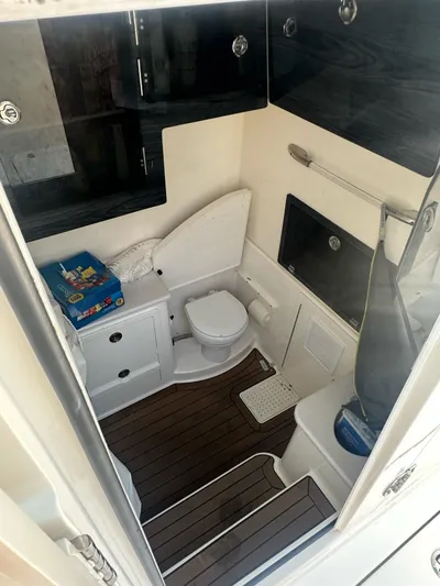 Yacht Photos Pics 2022 Cobia 350 Center Console boat interior with toilet and storage cabinets.