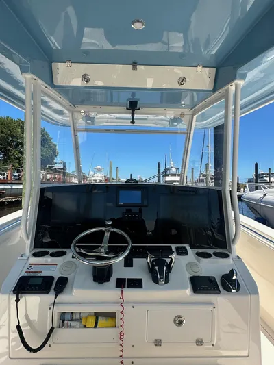  Yacht Photos Pics 2022 Cobia 350 Center Console boat helm with steering wheel and navigation controls.
