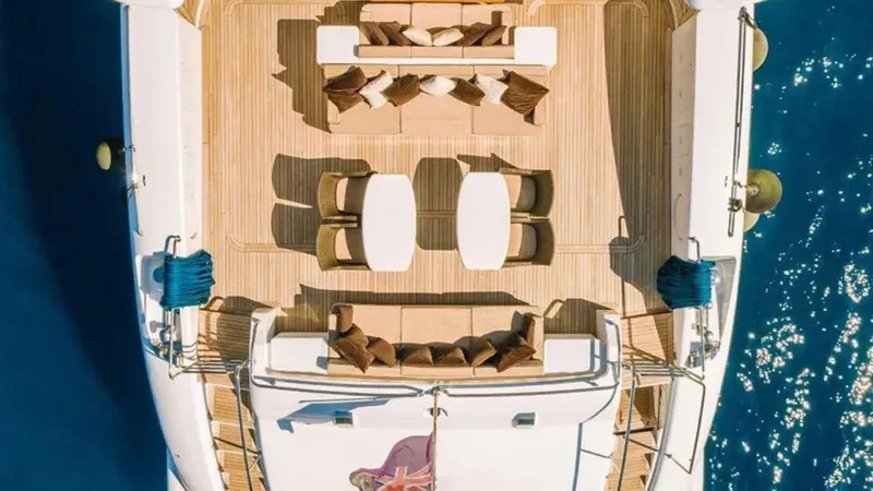  Yacht Photos Pics Luxurious 2009 Mangusta 165 yacht deck with elegant seating and tables, overlooking the ocean.