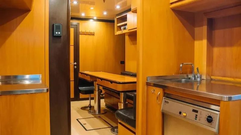  Yacht Photos Pics Interior of 2009 Mangusta 165 yacht with wooden cabinetry and dining area.