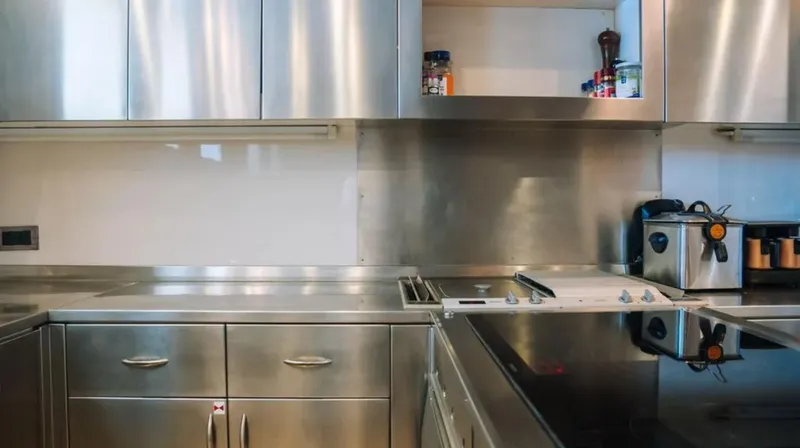  Yacht Photos Pics Modern stainless steel kitchen with sleek cabinets and appliances, featuring a Mangusta 165 yacht interior.