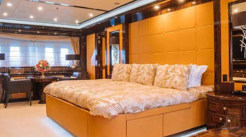  Yacht Photos Pics Luxurious bedroom interior on 2009 Mangusta 165 yacht, featuring elegant decor and plush bedding.
