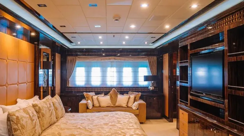  Yacht Photos Pics Luxurious bedroom interior on 2009 Mangusta 165 yacht, featuring elegant decor and modern amenities.