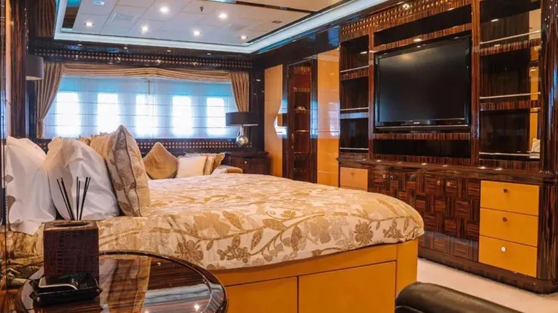  Yacht Photos Pics Luxurious bedroom interior on 2009 Mangusta 165 yacht, featuring elegant decor and modern amenities.