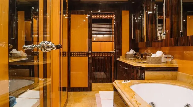  Yacht Photos Pics Luxurious bathroom interior on 2009 Mangusta 165 yacht, featuring elegant wood and marble finishes.