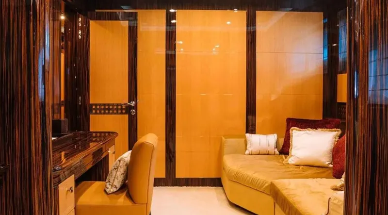  Yacht Photos Pics Luxurious interior of 2009 Mangusta 165 yacht with elegant wood paneling and plush seating.