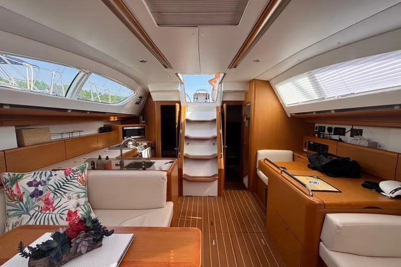  Yacht Photos Pics Luxurious interior of a 2011 Jeanneau 50 DS sailboat with elegant wood finishes.