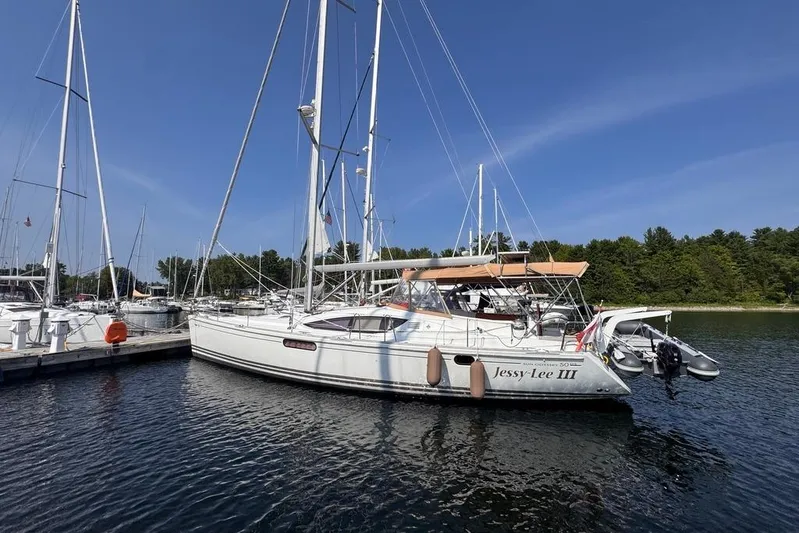  Yacht Photos Pics 2011 Jeanneau 50 DS sailboat docked in a serene marina setting.