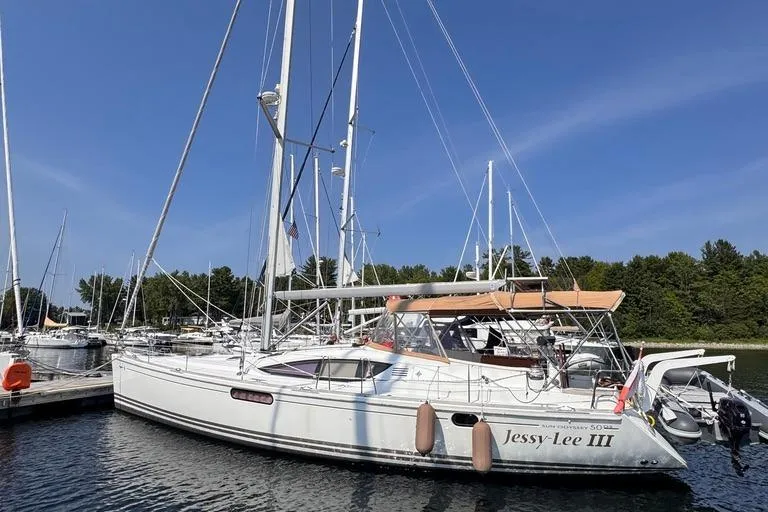  Yacht Photos Pics 2011 Jeanneau 50 DS sailboat docked in a marina under a clear blue sky.