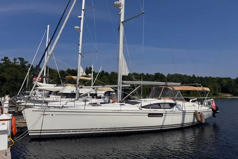  Yacht Photos Pics 2011 Jeanneau 50 DS sailboat docked on a calm lake with clear skies.
