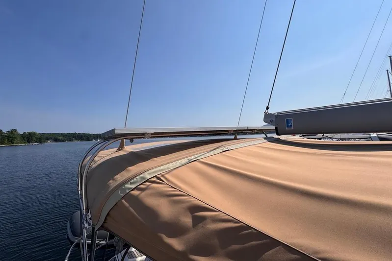  Yacht Photos Pics 2011 Jeanneau 50 DS sailboat with tan canopy on calm water under clear sky.