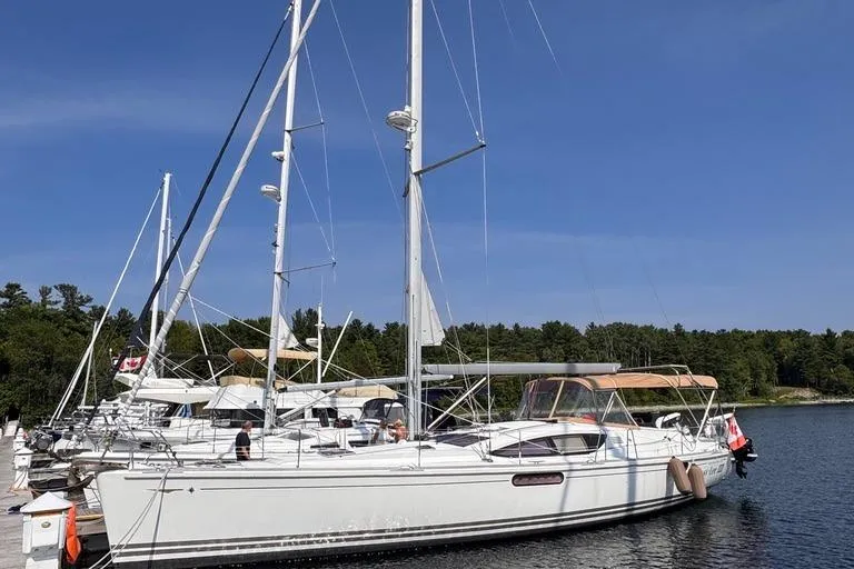  Yacht Photos Pics 2011 Jeanneau 50 DS sailboat docked in a serene marina setting.