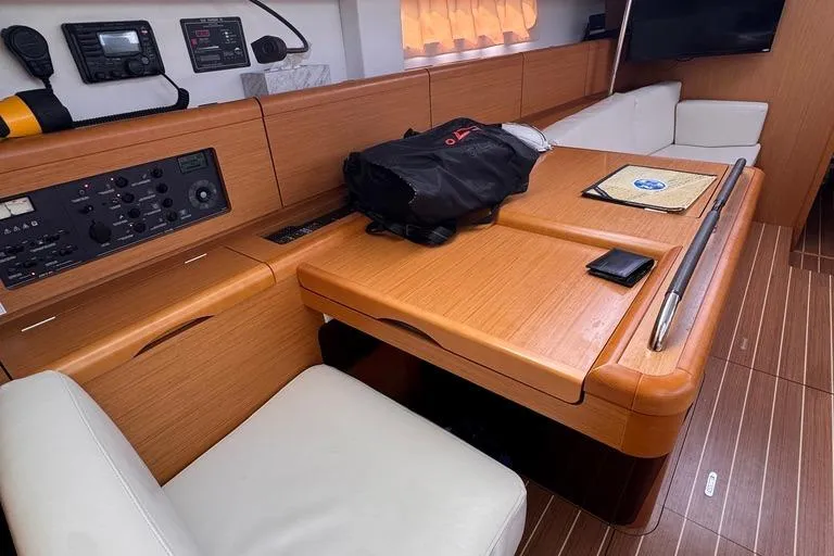  Yacht Photos Pics Interior of 2011 Jeanneau 50 DS yacht with navigation station and seating area.