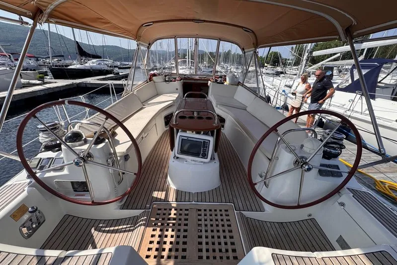  Yacht Photos Pics 2011 Jeanneau 50 DS sailboat cockpit with dual steering wheels, docked at marina.