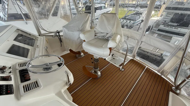 Steel Mahlin Yacht Photos Pics 2006 Ocean Yachts 57 Super Sport helm with captain's chair and teak flooring.