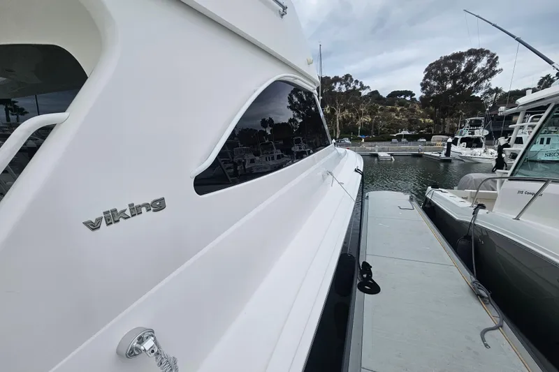 Team Turbo Yacht Photos Pics 2013 Viking 42 Convertible yacht docked at marina, side view.