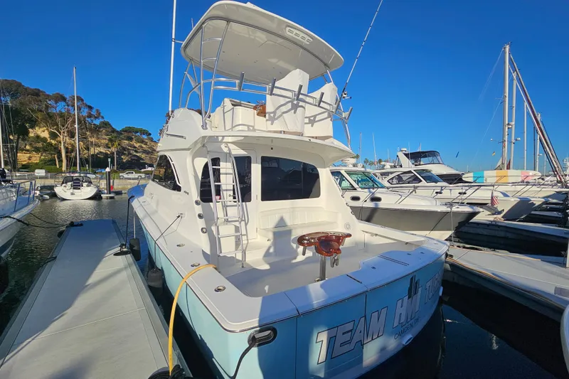 Team Turbo Yacht Photos Pics 2013 Viking 42 Convertible yacht docked at marina under clear blue sky.