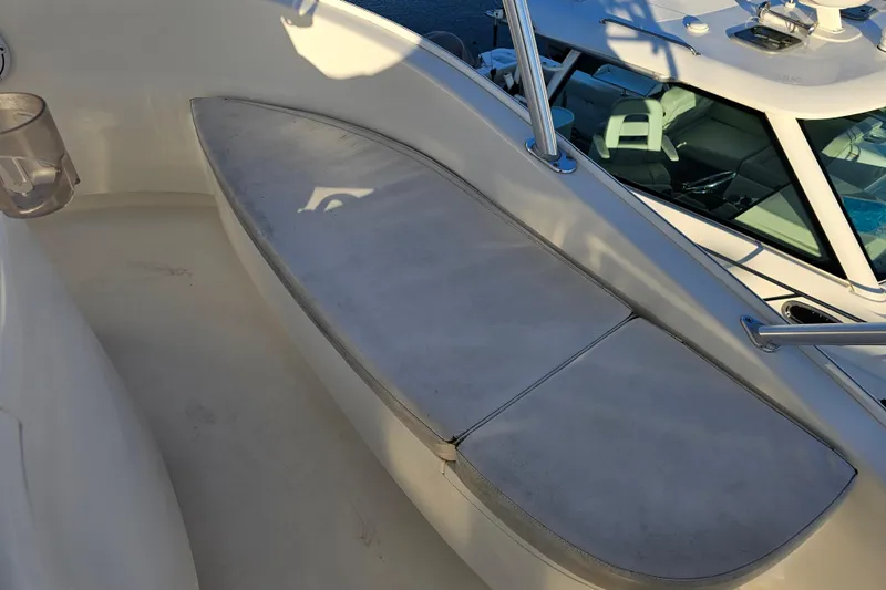 Team Turbo Yacht Photos Pics 2013 Viking 42 Convertible boat seating area with cushioned bench and railing.