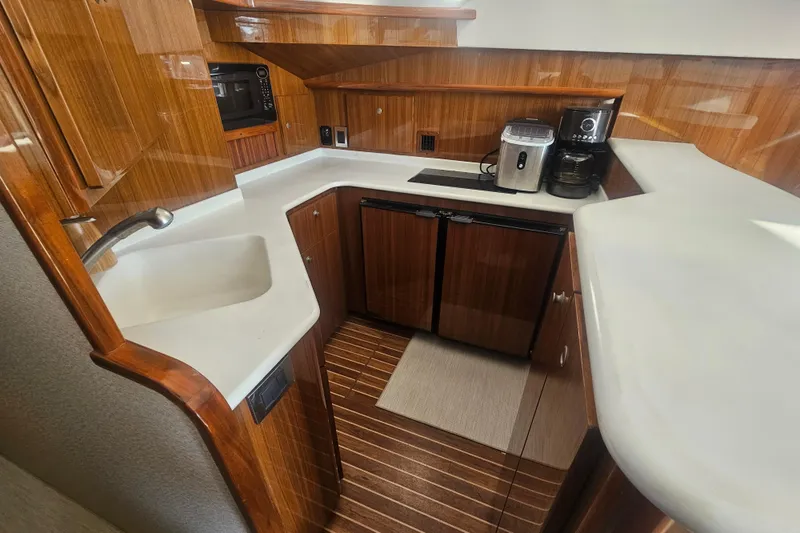 Team Turbo Yacht Photos Pics Luxurious 2013 Viking 42 Convertible yacht kitchen with wood cabinetry and modern appliances.