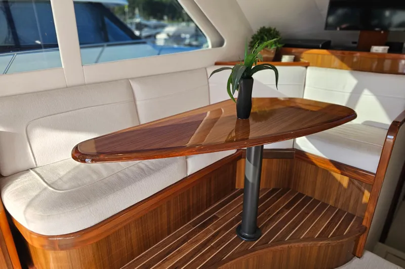 Team Turbo Yacht Photos Pics Luxurious interior of 2013 Viking 42 Convertible yacht with elegant wood table and seating.