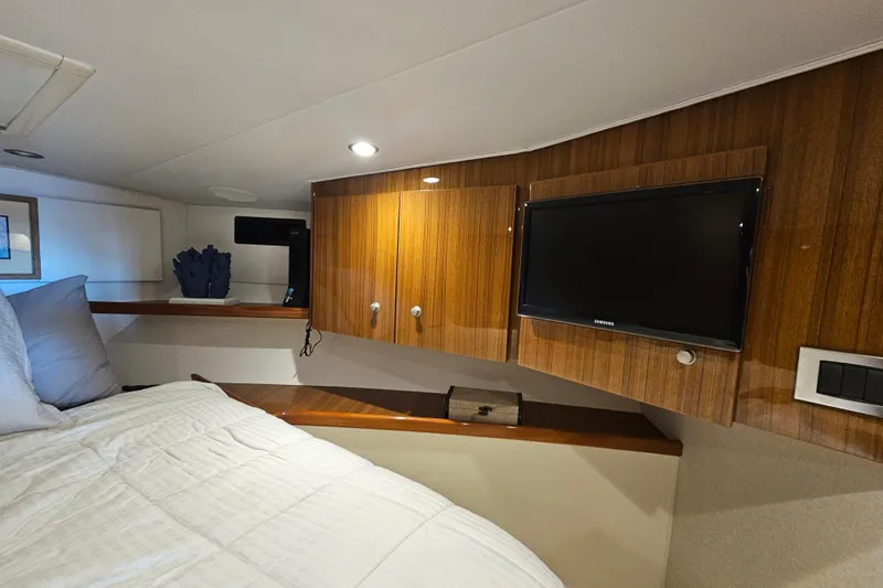 Team Turbo Yacht Photos Pics 2013 Viking 42 Convertible yacht interior with wood paneling and mounted TV.