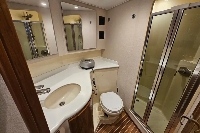 Team Turbo Yacht Photos Pics Bathroom interior of 2013 Viking 42 Convertible yacht with shower and vanity.