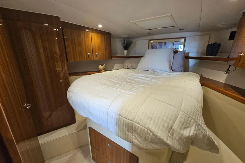 Team Turbo Yacht Photos Pics Luxurious bedroom interior of 2013 Viking 42 Convertible yacht with wood cabinetry.