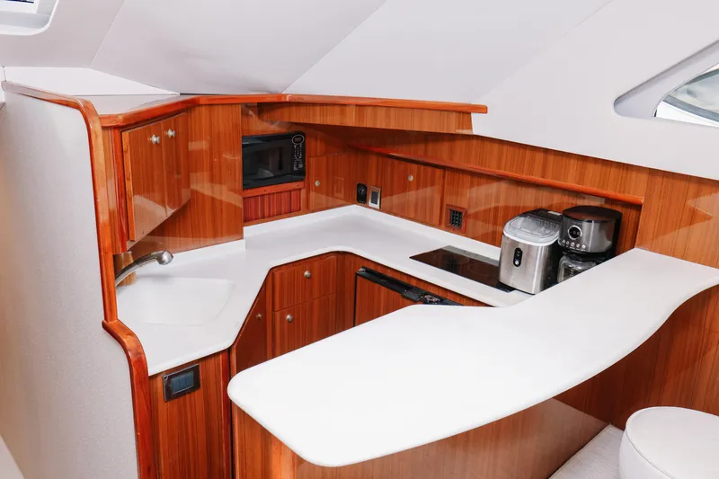 Team Turbo Yacht Photos Pics Luxurious galley in 2013 Viking 42 Convertible yacht with modern appliances and sleek wood cabinetry.