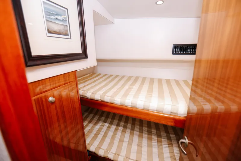 Team Turbo Yacht Photos Pics 2013 Viking 42 Convertible yacht cabin with bunk beds and wooden cabinetry.