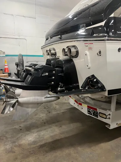  Yacht Photos Pics 2012 Cigarette 50' Marauder AMG boat stern with powerful outboard motor in a garage.