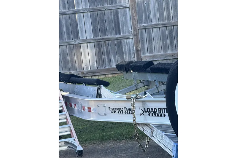  Yacht Photos Pics Trailer for 2018 Nor-Tech 340 Sport Center Console near wooden fence.