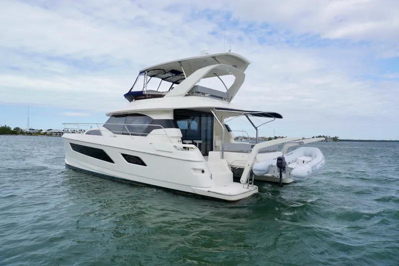 Sandals Yacht Photos Pics 2017 Aquila 44 Yacht cruising on open water under a cloudy sky.