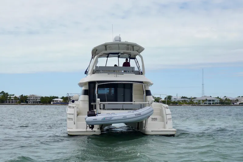 Sandals Yacht Photos Pics Aquila 44 Yacht 2017 on water, rear view with inflatable boat.