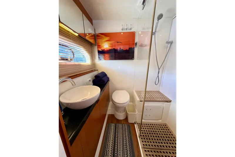 Sandals Yacht Photos Pics Luxurious bathroom in 2017 Aquila 44 Yacht with modern fixtures and sunset artwork.