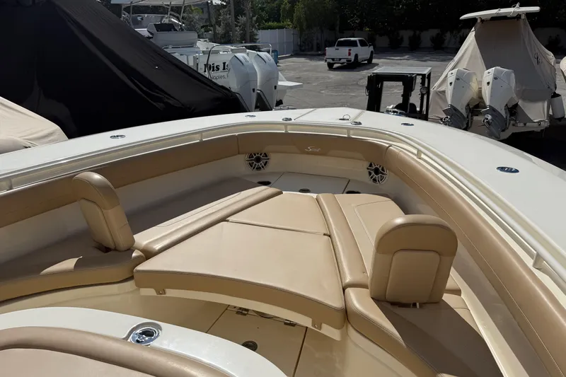  Yacht Photos Pics 2022 Scout 355 LXF boat with tan seating and sleek design in a marina setting.