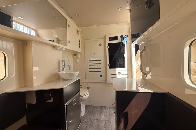  Yacht Photos Pics Interior of 2022 Scout 355 LXF boat featuring modern bathroom amenities and sleek design.