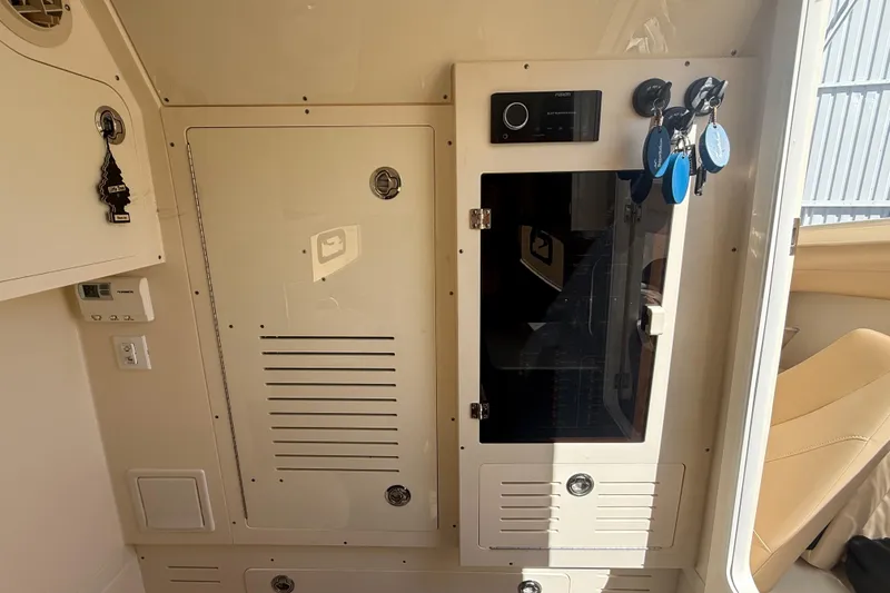  Yacht Photos Pics Interior view of a 2022 Scout 355 LXF boat, featuring control panels and storage compartments.