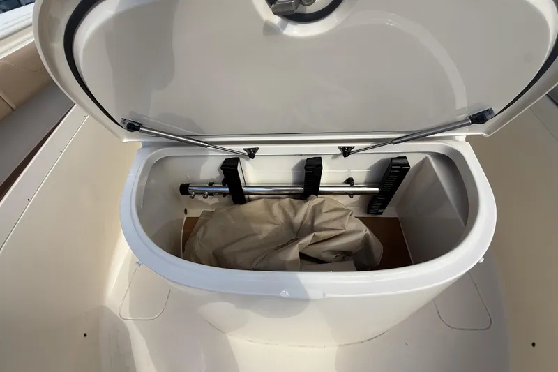  Yacht Photos Pics Open storage compartment on 2022 Scout 355 LXF boat, showing interior contents.