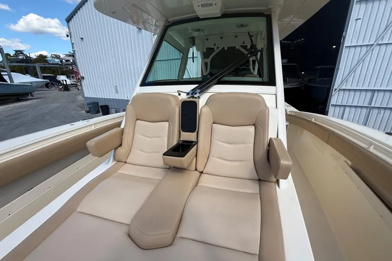  Yacht Photos Pics 2022 Scout 355 LXF boat interior with beige seating and armrests.