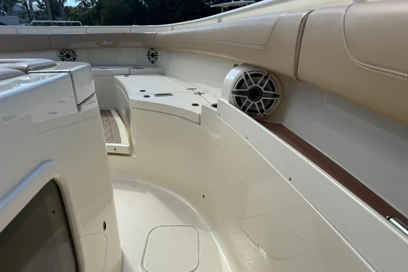  Yacht Photos Pics 2022 Scout 355 LXF boat interior with beige seating and built-in speakers.