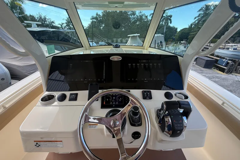  Yacht Photos Pics 2022 Scout 355 LXF boat helm with modern controls and steering wheel.