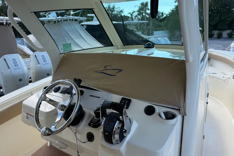  Yacht Photos Pics 2022 Scout 355 LXF boat helm with Mercury controls and covered dashboard.