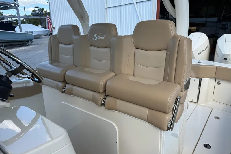  Yacht Photos Pics 2022 Scout 355 LXF boat with luxurious beige seating and steering wheel.
