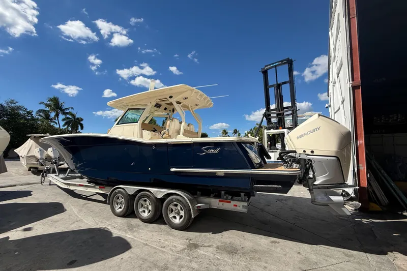  Yacht Photos Pics 2022 Scout 355 LXF boat on trailer under clear blue sky.