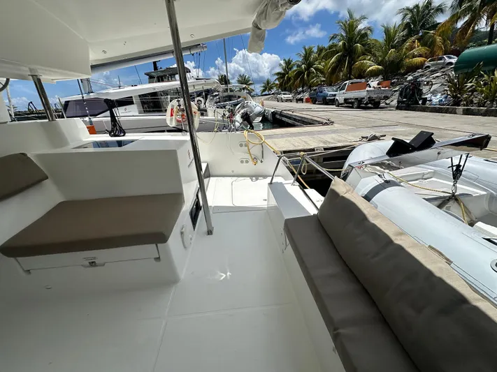 Goin' Coastal Yacht Photos Pics 2018 Fountaine Pajot Helia 44 Evolution catamaran docked, featuring spacious seating and tropical backdrop.