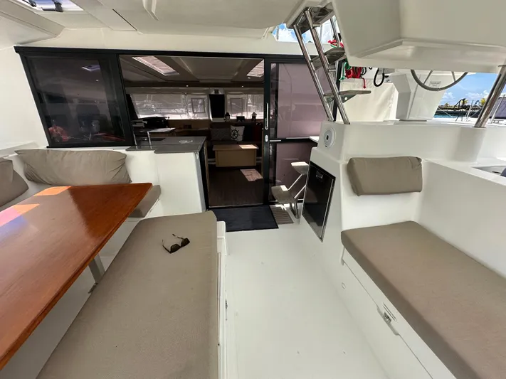 Goin' Coastal Yacht Photos Pics Spacious interior of 2018 Fountaine Pajot Helia 44 Evolution catamaran with seating and table.