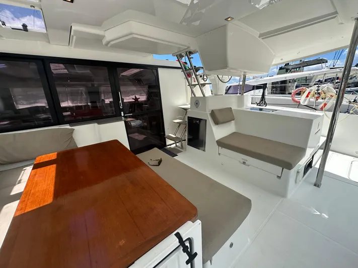 Goin' Coastal Yacht Photos Pics Spacious deck of 2018 Fountaine Pajot Helia 44 Evolution catamaran with seating and table.