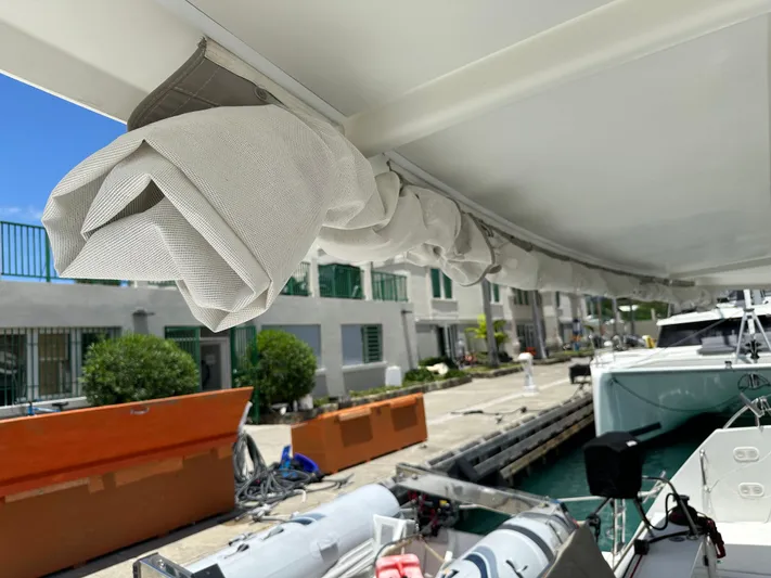 Goin' Coastal Yacht Photos Pics 2018 Fountaine Pajot Helia 44 Evolution docked, showcasing rolled-up sail and marina setting.